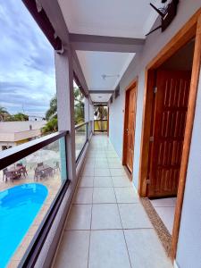a balcony with a view of a swimming pool at Hotel Vila dos Pescadores in Aparecida