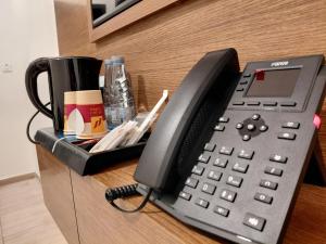 a black office phone sitting on top of a desk at شقق منازل الشرقية للشقق الفندقية in Dammam +7 photos