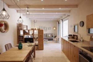 a kitchen and living room with a table and a couch at Borgo Lianti case vacanza Sardegna in San Pasquale