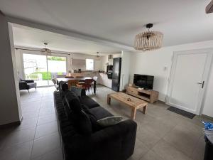 a living room with a couch and a table at Maison à Dol de Bretagne in Dol-de-Bretagne