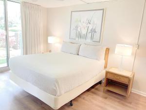 a white bed in a room with a window at Maui Eldorado Condo D108 in Kaanapali +28 photos