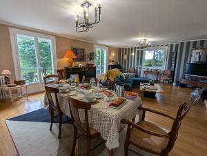 a living room with a table and chairs and a living room at La Chesnaie in Bonnes +35 photos