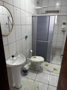 a bathroom with a shower and a sink and a toilet at Taba House in São Gabriel