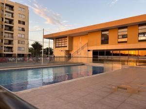 a building with a swimming pool in front of a building at Corazón de quilla in Barranquilla