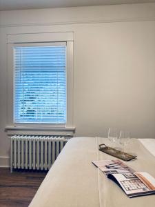 a table with two wine glasses and a window at Deluxe Master Queen Bedroom with Bathroom in Vancouver West in Vancouver +1 photo