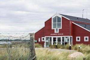 a red building with a fence in front of it at 40164-Juelsminde-Hybenvej-17 in Juelsminde