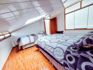 a bedroom on a yacht with a bed and a window at duplex acogedor in Cusco
