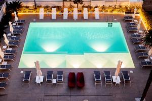 an overhead view of a swimming pool with lounge chairs and a pool at Residence Cristallo Senigallia in Senigallia