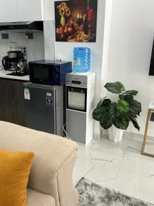 a living room with a stove and a kitchen at SamHomes in Nairobi