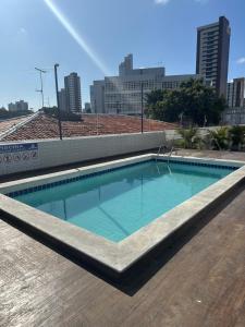 a swimming pool on the roof of a building at Apart amplo, equipado e cama king in João Pessoa