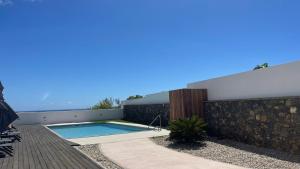 a swimming pool on the roof of a house at Atlantic Golden View Luxe Apartment in Ponta Delgada