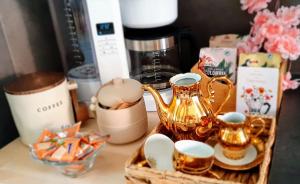 a table with a tea set and cups and a coffee maker at Casa 1895- where history meets comfort in Žalec +24 photos