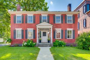 a red brick house with a white door at Waterbury Studio 12 Mi to Bolton Valley Ski Resort in Waterbury