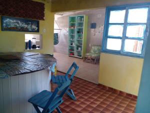 two blue chairs sitting at a counter in a room at Naviooceanico in Saquarema