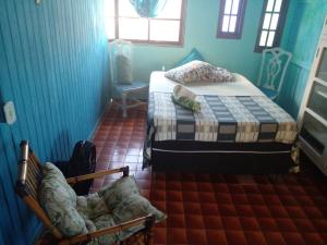 a bedroom with two beds and a chair in it at Naviooceanico in Saquarema +33 photos