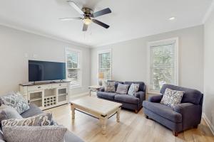 a living room with two couches and a flat screen tv at Beaufort Villas #A in Beaufort