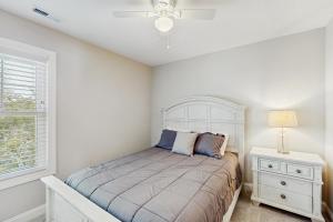 a bedroom with a bed and a nightstand and a window at Beaufort Villas #A in Beaufort