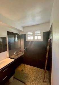 a bathroom with a glass shower and a sink at Very nice villa with pool, sea view, large land in Le Gosier +30 photos