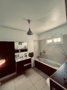 a bathroom with a tub and a sink at Very nice villa with pool, sea view, large land in Le Gosier