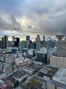 a view of a large city with a stratosphere at Cozy Gastown condo with a view! in Vancouver