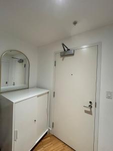 a room with a white door and a mirror at Cozy Gastown condo with a view! in Vancouver