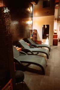 a row of green chairs in a room at Villa Tradycja in Białystok