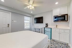 a bedroom with a bed and a ceiling fan at Sweet Studio Suite in Rockport