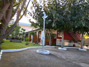 a cross on a pole in front of a building at Casablanca El Petit Hotel in Deltebre