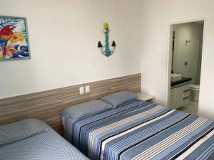 a bedroom with a bed and a sink and a mirror at Apart Hotel Marinas Tamandaré - apt 304 in Tamandaré +9 photos