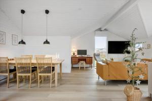 a dining room and living room with a table and chairs at 30156-Odder-Chr-Christensensvej-4 in Beder