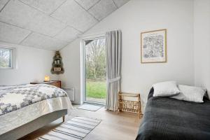 a bedroom with a bed and a window at 30156-Odder-Chr-Christensensvej-4 in Beder