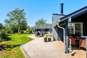a house with a deck and a patio at 30156-Odder-Chr-Christensensvej-4 in Beder