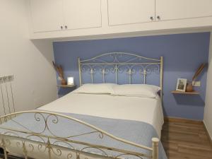 a bedroom with a bed with a blue wall at La casa di mamma in Monopoli