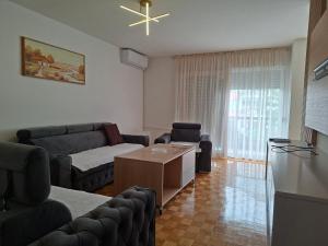 a living room with a couch and a table at Apartman Borik in Banja Luka
