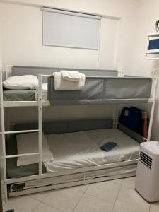 a room with two bunk beds in a room at Riposto Sea & Etna View Retreat in Riposto
