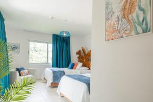 a bedroom with two beds and a window at Hermosa Wave A2 & B2 in Playa Hermosa +41 photos