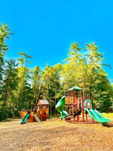 a group of playground equipment in a park at Quechee Pine Valley Campground in Hartford