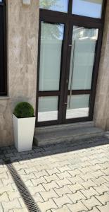 a glass door with a plant in front of it at Студио in Burgas City +3 photos