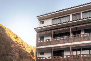 a building on the side of a mountain at Ayra Hotel Boutique in Pisac