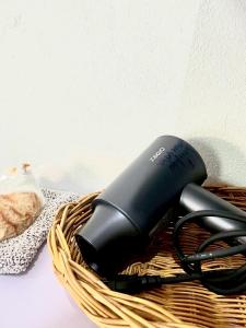 a wicker basket with a hair dryer in it at Yada House twin bed in Nai Yang Beach