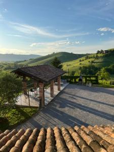a pavilion with a table and chairs and a roof at Agriturismo Rio Sordo in Barbaresco