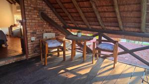 a table and two chairs sitting on a porch at Dika Dika Den in Phalaborwa