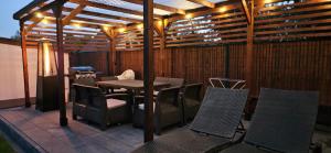 a patio with a table and chairs and a grill at Sielskie Sitno in Sitno