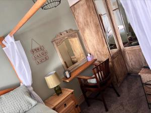an overhead view of a bedroom with a mirror and a chair at Nettle Cottage in Heysham