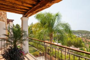 a balcony with a view of palm trees at New! Villa Llosas de Dalt in Sant Carles de Peralta