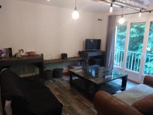 a living room with a couch and a coffee table at Appartement dans copropriété arborée in Saint-Jacques-de-la-Lande