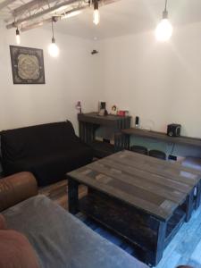 a living room with a table and a couch at Appartement dans copropriété arborée in Saint-Jacques-de-la-Lande +9 photos