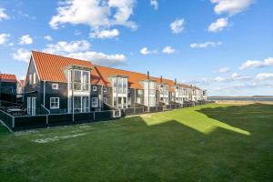 a row of houses on a lawn near the ocean at 40172-Juelsminde-Strandengen-30 in Juelsminde