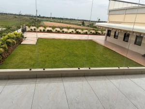 an aerial view of a lawn in front of a building at V guesthouse staycation in Bāpatla