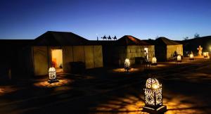 メルズーガにあるBest Merzouga Sahara Campの夜間の建物前の光の集団